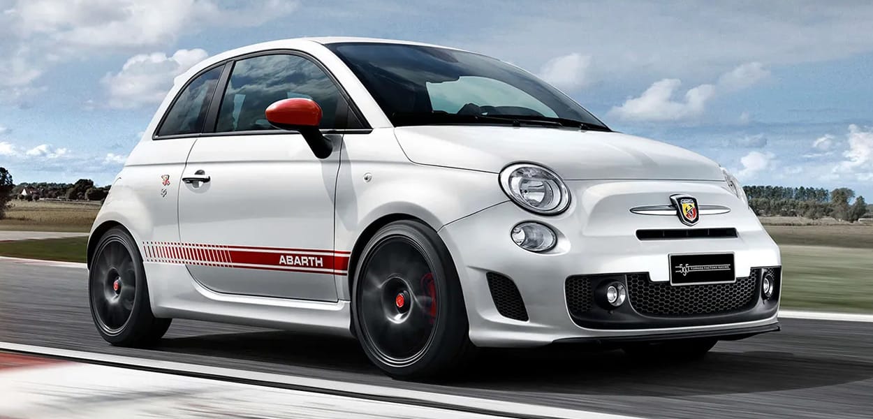 Ein rot-weißer Abarth 595 fährt auf einer Rennstrecke.